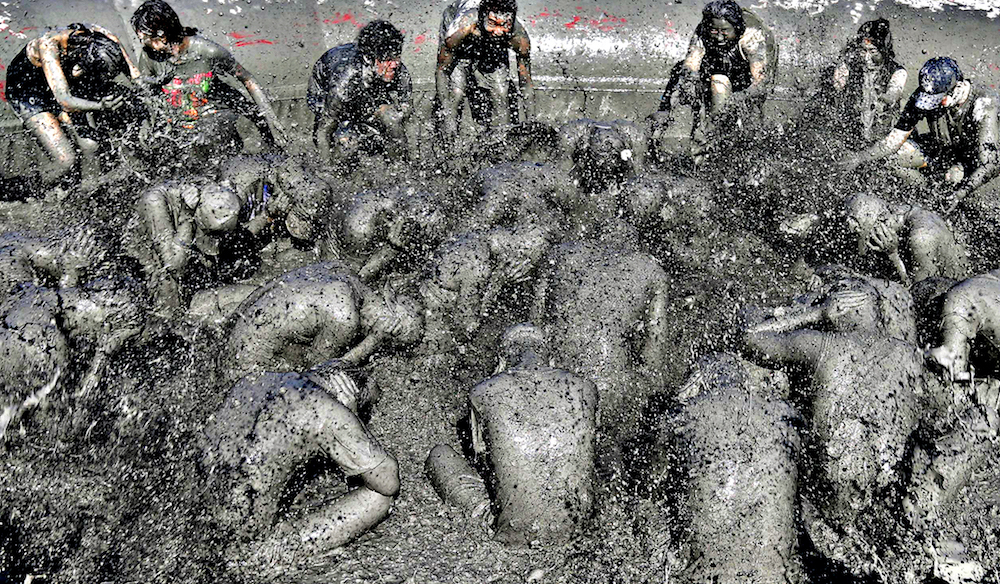 People play in the mud during the Boryeong Mud Festival at Daecheon beach in Boryeong...People play in the mud during the Boryeong Mud Festival at Daecheon beach in Boryeong, about 190 km (118 miles) southwest of Seoul, July 19, 2013. About 2 to 3 million domestic and international tourists visit the beach during the annual mud festival, according to the festival organisers. REUTERS/Lee Jae-Won (SOUTH KOREASOCIETY TRAVEL - Tags: TRAVEL TPX IMAGES OF THE DAY) SOCIETY